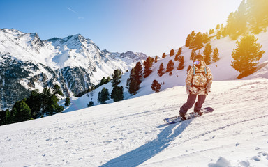 Skier in the freeride - Extreme young female snowboarder enjoys the picturesque view of the...
