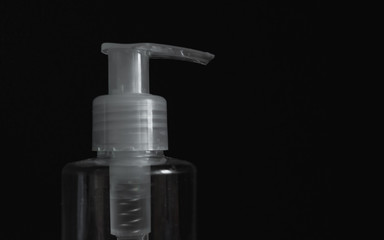 Fototapeta na wymiar Dispenser bottles with antiseptic on a black background. Bottle of hand sanitizer. Coronavirus disinfectants, Covid19 disinfectants.