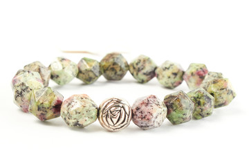 bracelet made of Zoisite beads on a white background. close up