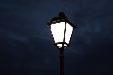 Fototapeta na wymiar Old lantern in london. Glowing street lamp in London. London lighting.