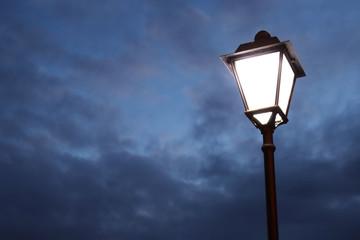 Fototapeta na wymiar Lamppost on a London street. London lantern. Glowing lantern