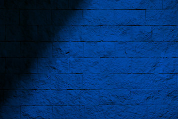 Blue background with shadow. Blue brick wall