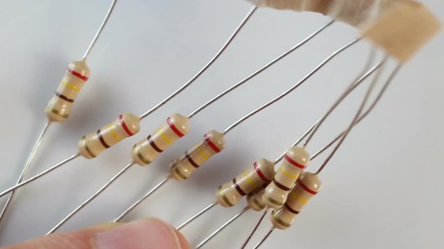 fixed (fixed-value) permanent resistor on a white background. Extreme close-up, real time, low depth of field-contains people