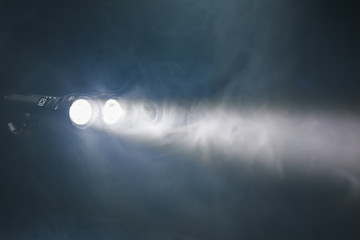 ray of double pocket flashlight in smoke, copy-space background