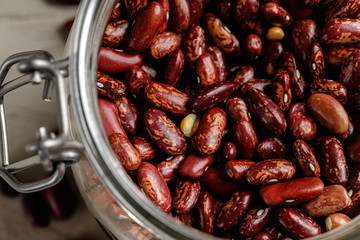 Raw cereals or beans in glass jars close up. Vegan and vegetarian food. Close up.