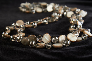 pearl necklace with semi-precious stone on black velor. close up