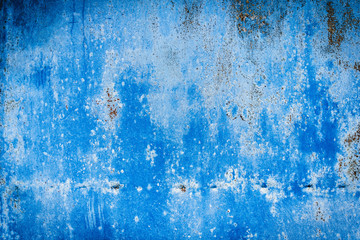 Texture of a rusty metal surface: dark blue, blue, aged cracked paint. Background of old painted sheet metal with rust painted in blue.