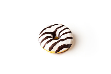 Glazed striped donut on white background, isolated. Party food concept with copy space. Top view.