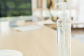 An alcohol gel bottle is on the desk in the home office.