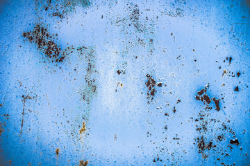 Texture of a rusty metal surface: dark blue, blue, aged cracked paint. Background of old painted sheet metal with rust painted in blue.