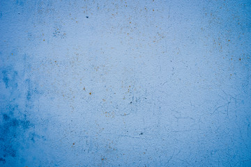 Texture of a rusty metal surface: dark blue, blue, aged cracked paint. Background of old painted sheet metal with rust painted in blue.