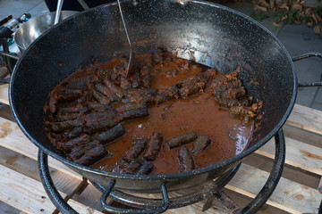 Cooking stew campfire concept, stew preparing open grill steaming.