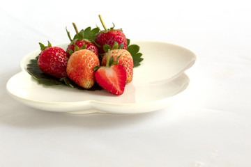 strawberries in a bowl on white background