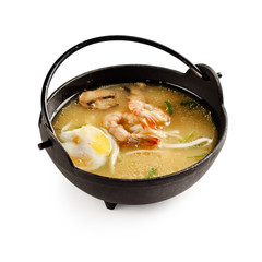 Traditional japanese miso soup with shrimp, mushrooms and egg on a white background