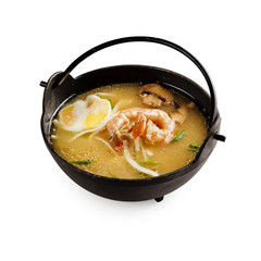Traditional japanese miso soup with shrimp, mushrooms and egg on a white background