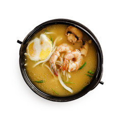 Traditional japanese miso soup with shrimp, mushrooms and egg on a white background