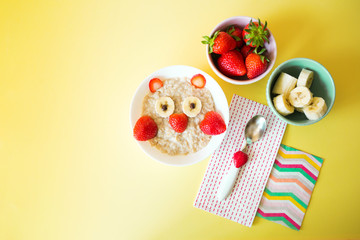 kid food. children's plate with oatmeal and strawberry owl. healthy breakfast