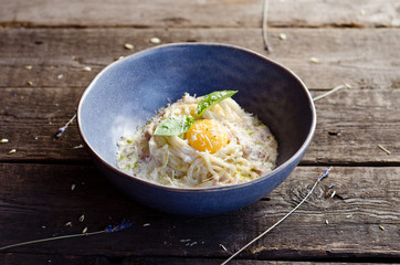 Carbonara pasta with bacon, cream sauce, Parmesan cheese and egg yolk. Traditional italian food.