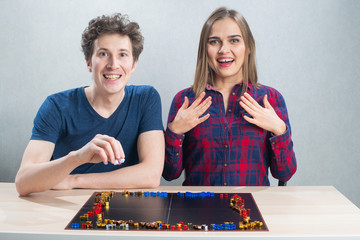 Board game playing, young family couple winning