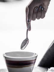 colorful cup and spoon held by girl hand