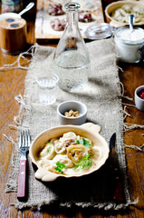 Boiled and baked dumplings in sour cream. Traditional meat dish of Russian cuisine