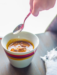 colored cup with meat soup
