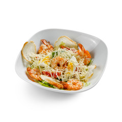Caesar Salad with grilled shrimps. Isolated on a white background.