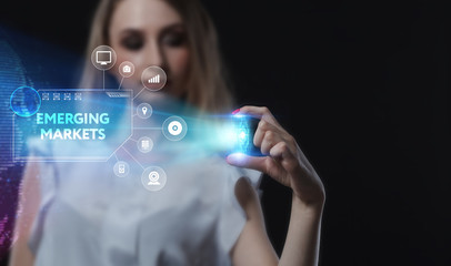 Business, Technology, Internet and network concept. Young businessman working on a virtual screen of the future and sees the inscription: Emerging markets