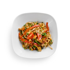 Fried udon noodles in a wok with chicken fillet and green beans. Traditional asian food. Isolated on white background.