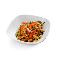 Fried udon noodles in a wok with chicken fillet and green beans. Traditional asian food. Isolated on white background.