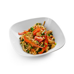 Fried udon noodles in a wok with chicken fillet and green beans. Traditional asian food. Isolated on white background.