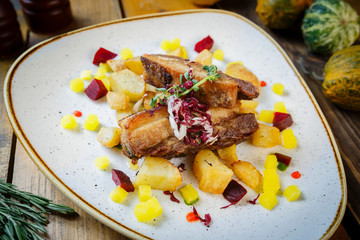 confit pork belly with beetrooth sweet potato and squash dressing
