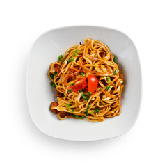 Fried udon noodles in a wok with chicken fillet and sauce. Traditional asian food. Isolated on a white background.