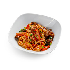 Fried udon noodles in a wok with pork in sweet and sour sauce. Traditional asian food. Isolated on a white background.