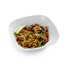Fried udon noodles in a wok with beef, bell pepper and broccoli. Traditional asian food. Isolated on a white background.