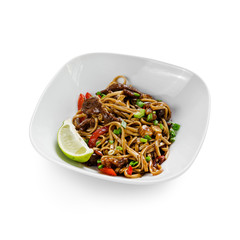Fried udon noodles in a wok with beef, bell pepper and broccoli. Traditional asian food. Isolated on a white background.
