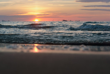 Sunset over the sea. Reflection of sunlight in the sea waves. The sky in the sunset rays.