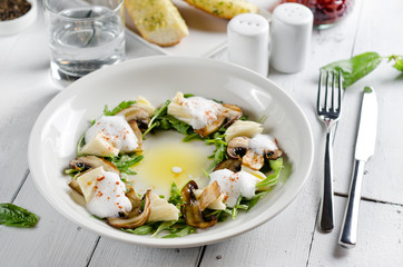 Appetizer with mozzarella cheese, arugula and mushrooms
