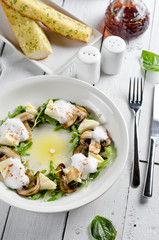 Appetizer with mozzarella cheese, arugula and mushrooms