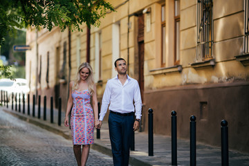 woman with her husband walking around the city, dressed neatly