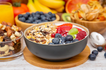 Group Fruits Breakfast mixed vegetables with salad bowl, nuts bowl, strawberry, banana, and pineapple, orange juice,  vitamin c in food  nature for health and diet in the top view on the wood table.