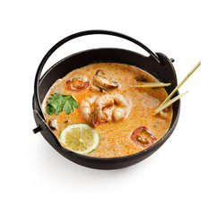 Soup Tom Yam. Thai spicy soup with shrimp and other seafood on a white background