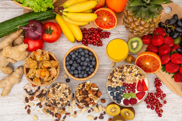 Group Fruits Breakfast mixed vegetables with salad bowl, nuts bowl, strawberry, banana, and pineapple, orange juice,  vitamin c in food  nature for health and diet in the top view on the wood table.