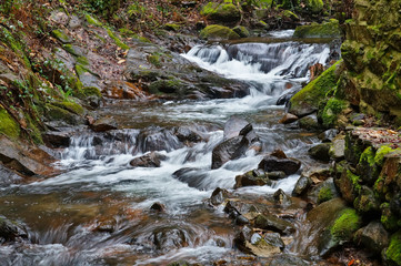 beautiful creek of Ribeira da Azenha near Espinhal in the forest between moss and stones