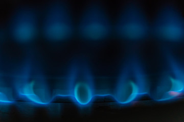 Blue flame of burning gas on a gas stove macro