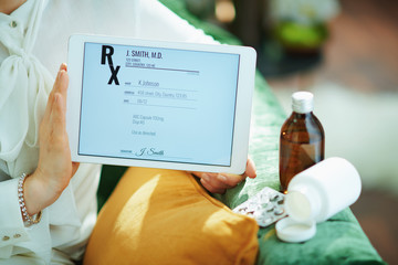woman showing electronic prescription on tablet PC
