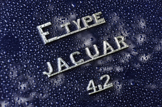 LONDON, UK - CIRCA SEPTEMBER 2011: Jaguar E-Type 4.2 sign after the rain. The E-Type was produced from 1961 until 1975 as a coupe and a convertible.