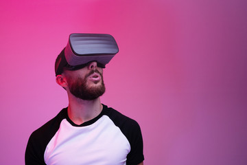 Excited man using Vr glasses using virtual reality technology