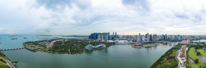 Fototapeta na wymiar View from above, stunning aerial view of the skyline of Singapore during a cloudy day with the financial district in the distance.