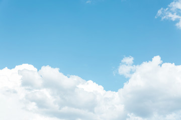 Fototapeta na wymiar A large white fluffy cloud against a blue sky.